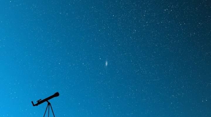 A telescope against a blue sky